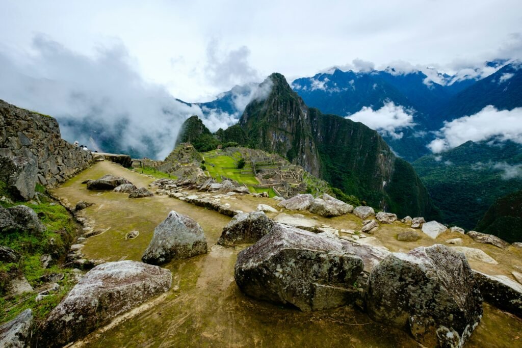 a view of a mountain range with rocks and grass